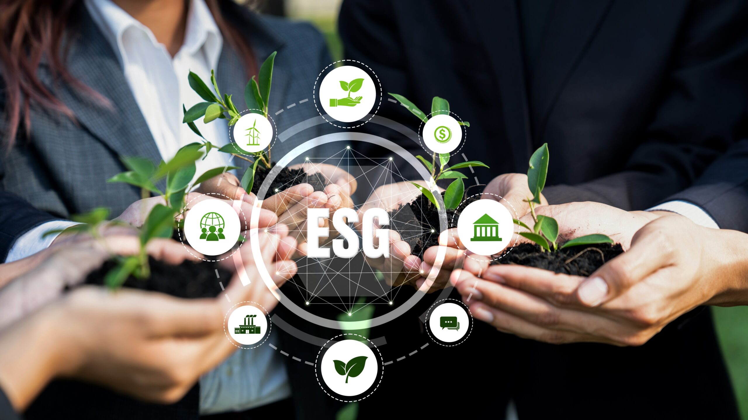 Hands holding plants with ESG symbols